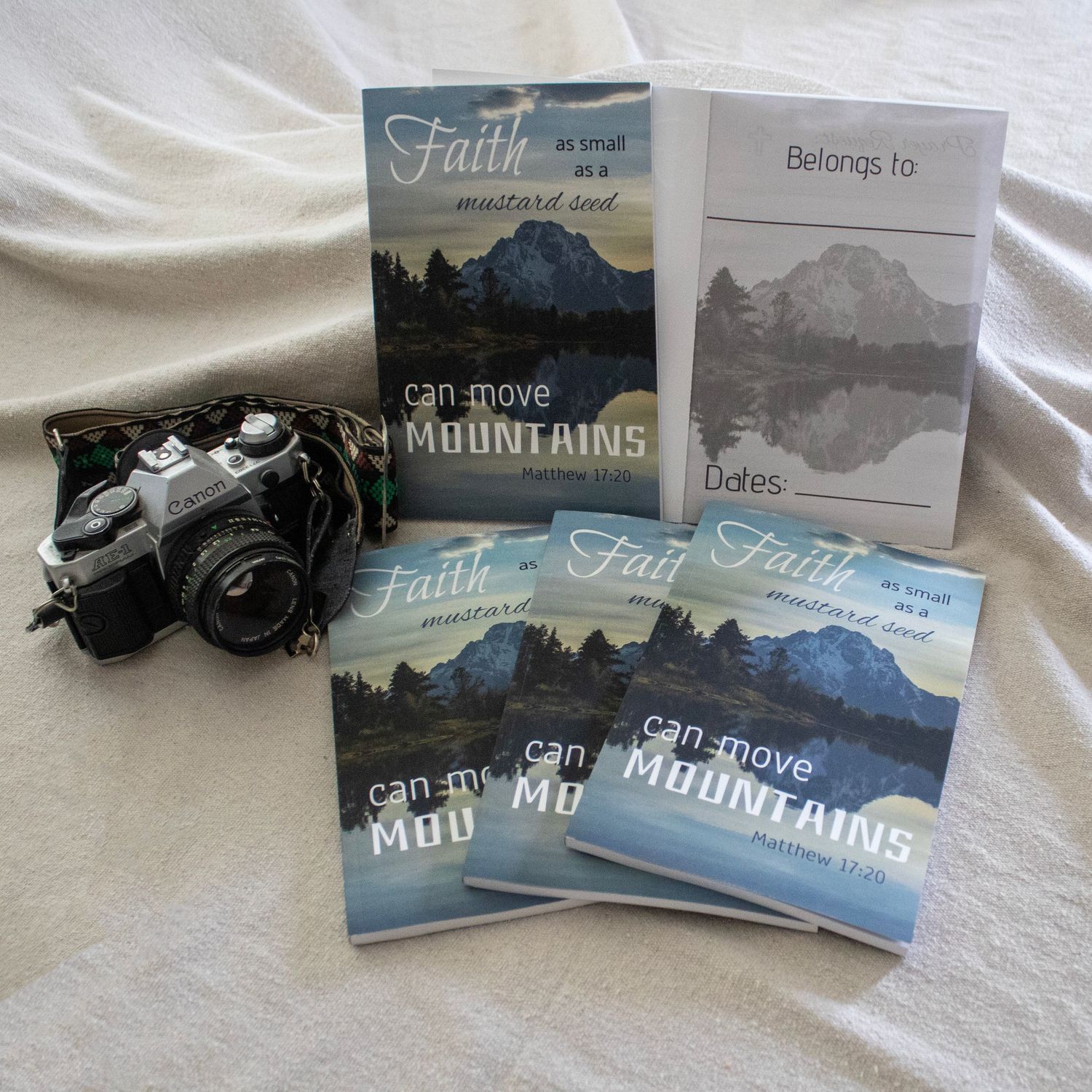 A few books laying on a table with a camera