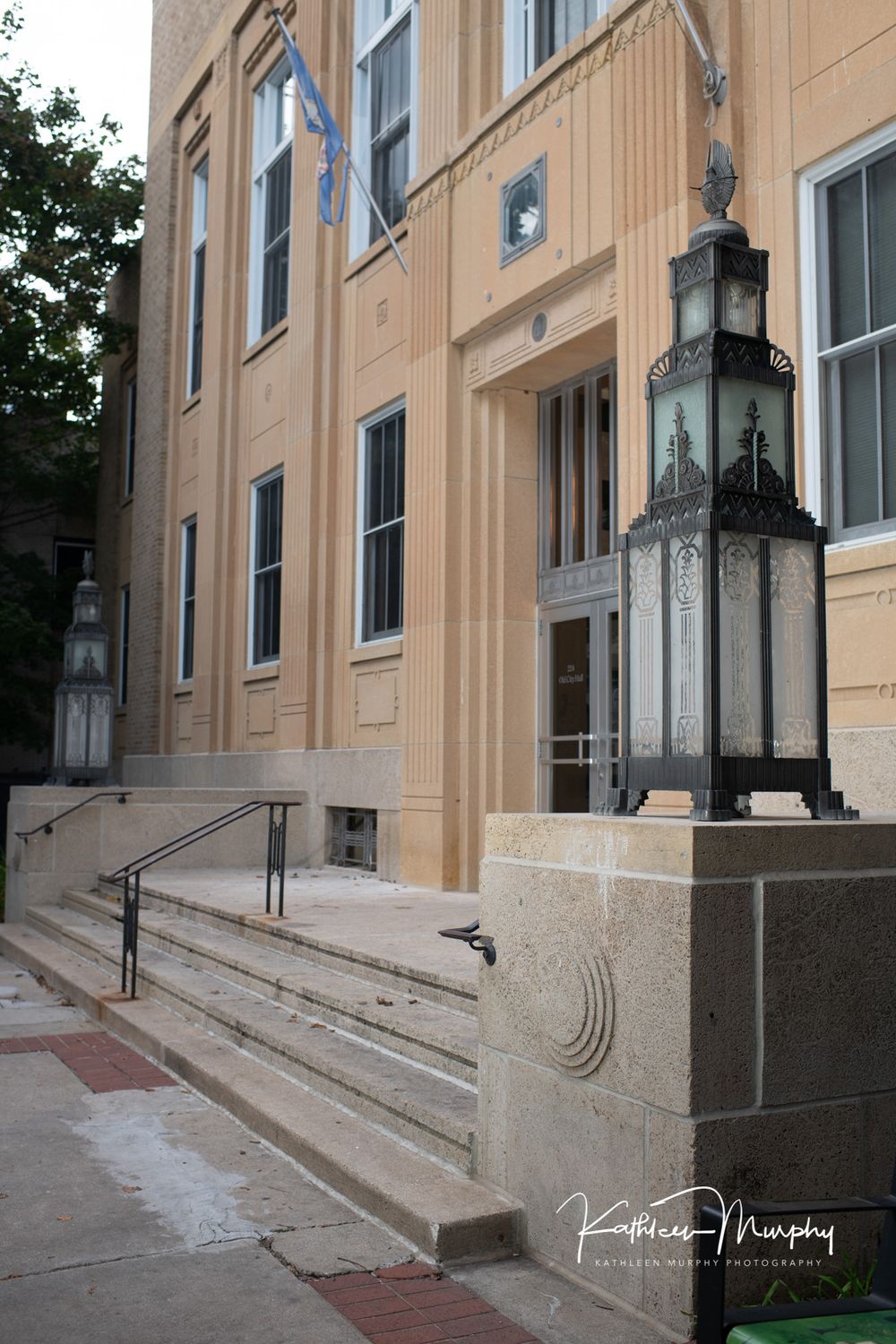 Historic building entrance with ornate lantern fixtures and stone steps.