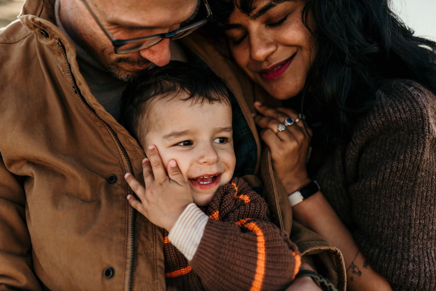 A warm family moment captured in intimate close-up during autumn.