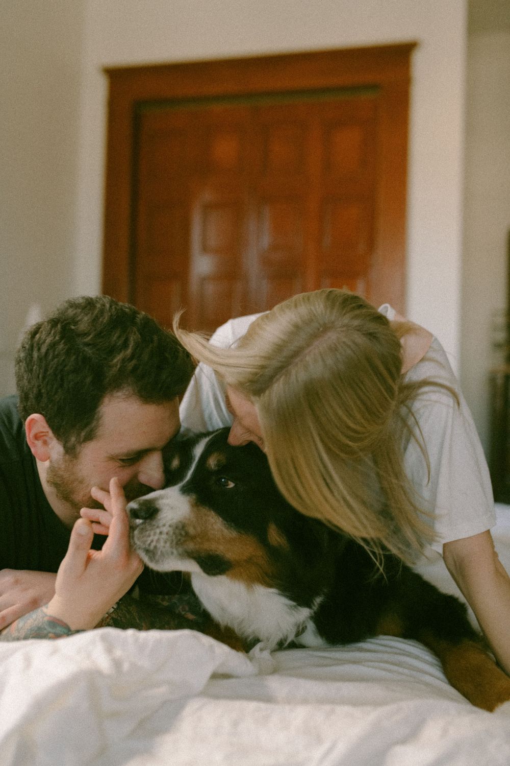 in home couples session with dog, in Grand Rapids michigan. cozy in home session. filmy family photos.