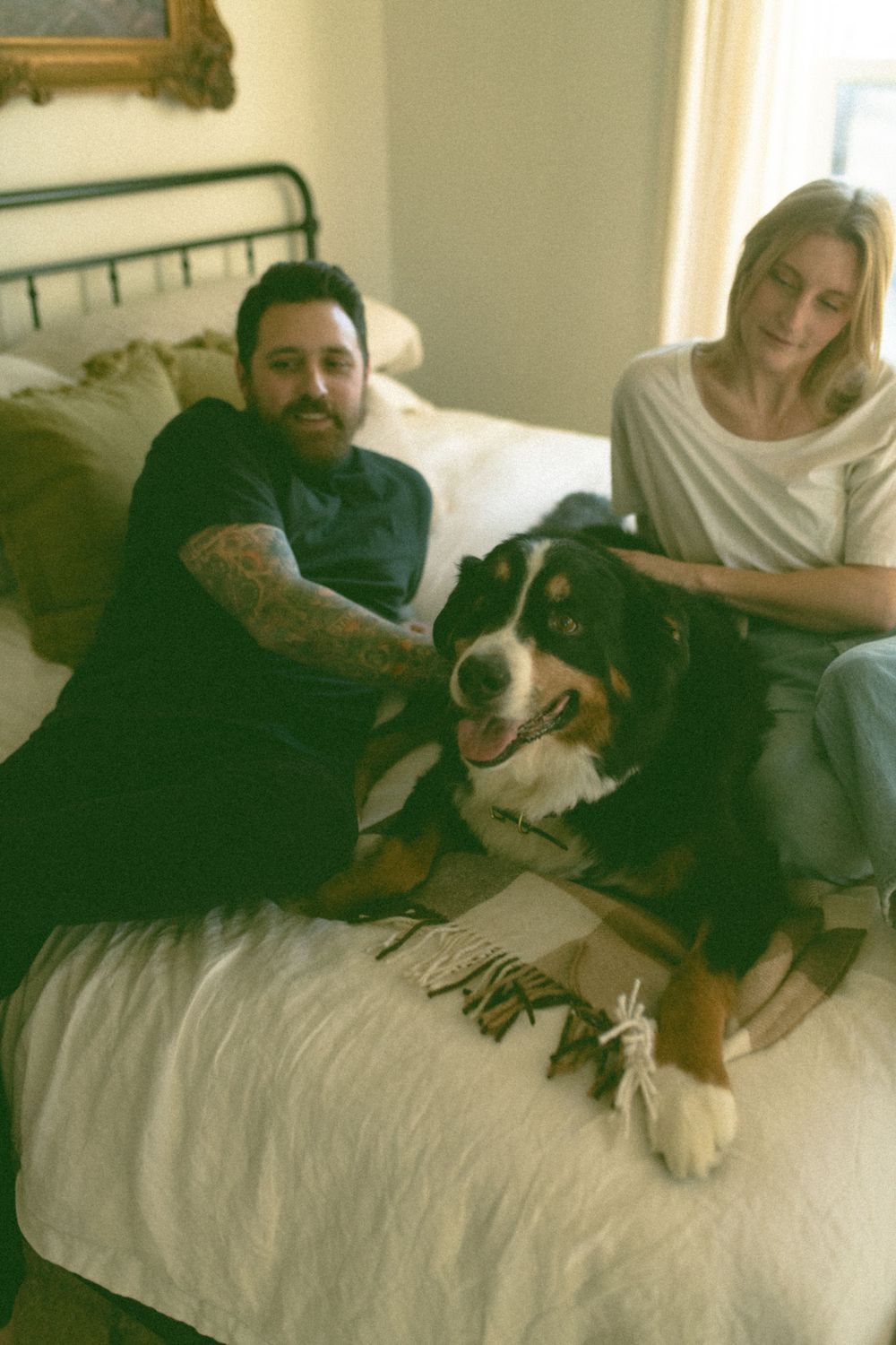 in home couples session with dog, in Grand Rapids michigan. cozy in home session. filmy family photos.