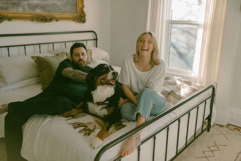 in home couples session with dog, in Grand Rapids michigan. cozy in home session. filmy family photos.