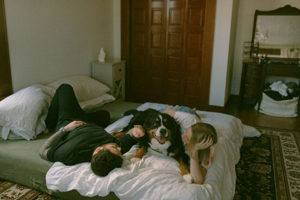 in home couples session with dog, in Grand Rapids michigan. cozy in home session. filmy family photos.