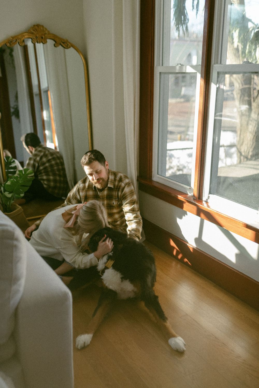 in home couples session with dog, in Grand Rapids michigan. cozy in home session. filmy family photos.