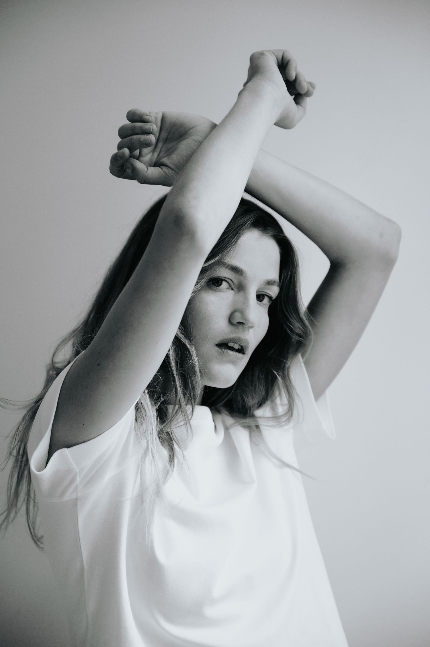 Minimalist black and white portrait series with flowing movement in white shirt.