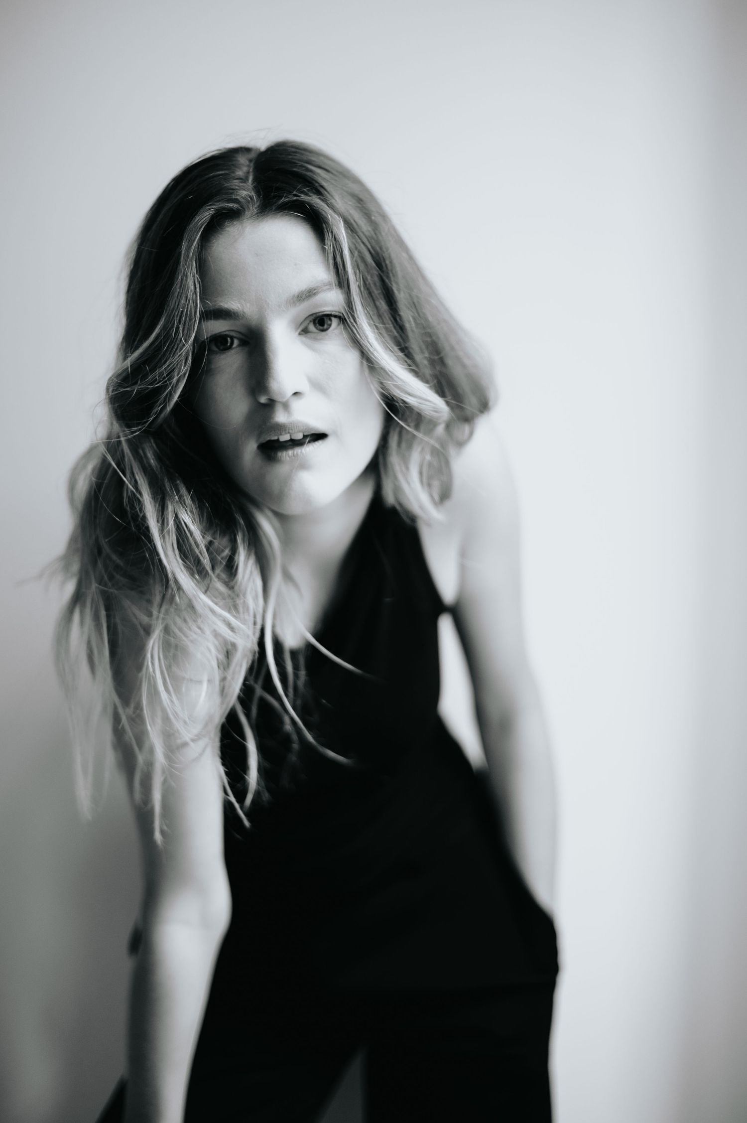 Artistic fashion sequence with flowing hair movement in high contrast lighting.