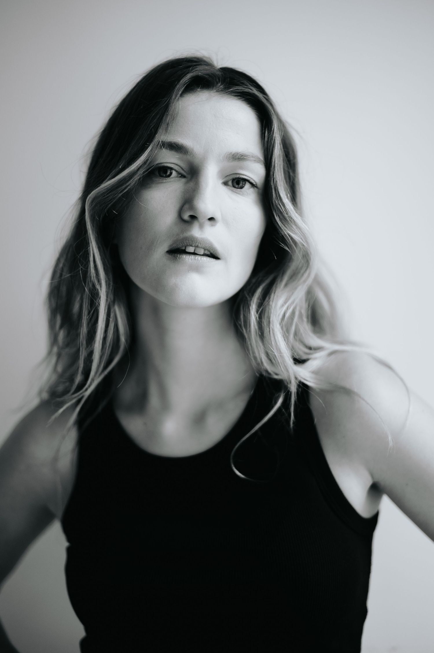 Monochrome studio portraits showing dynamic poses and expressions against white background.