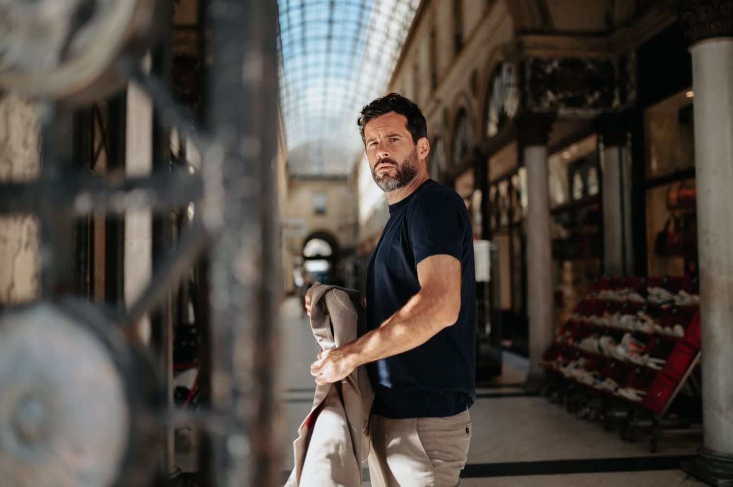 Interior shots of a historic shopping arcade with glass ceiling and elegant architecture.
