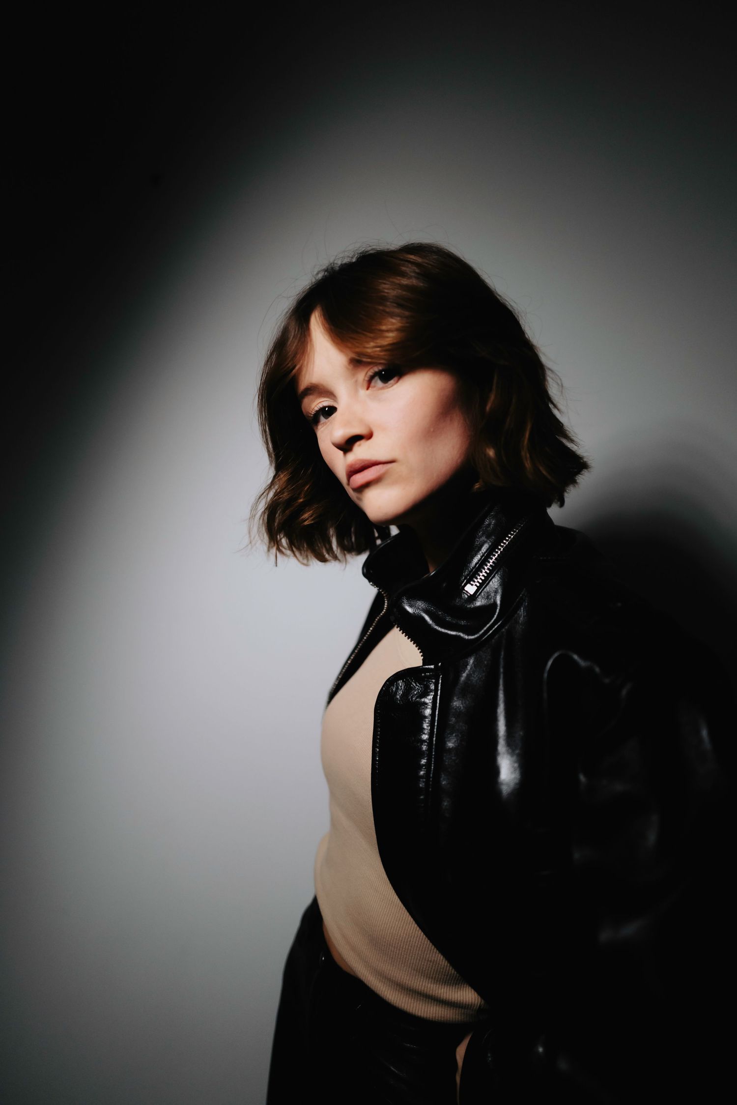 Artistic fashion portraits with dramatic side lighting and leather collar details.