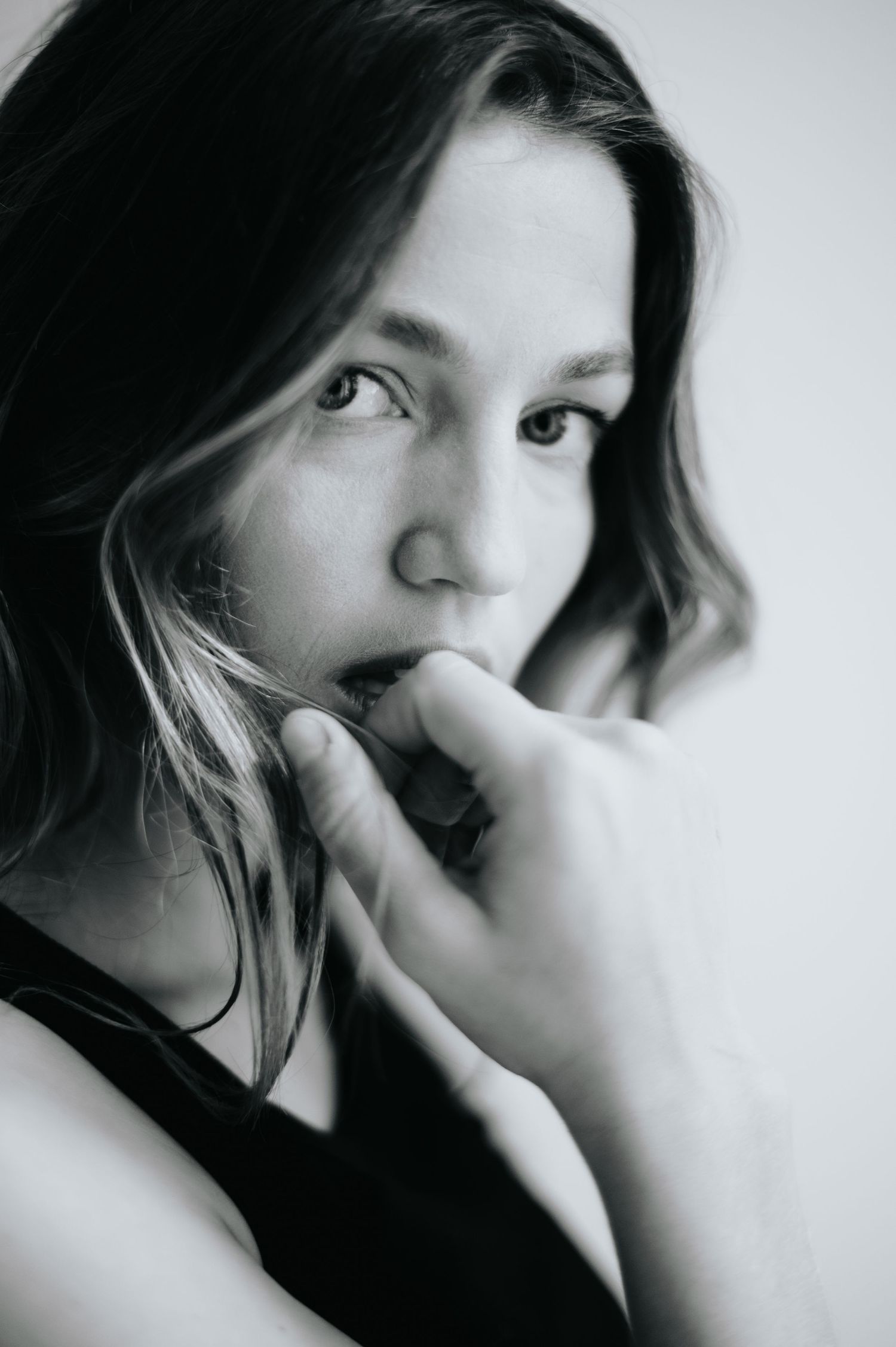 Intimate black and white close-up portraits showing contemplative expressions.