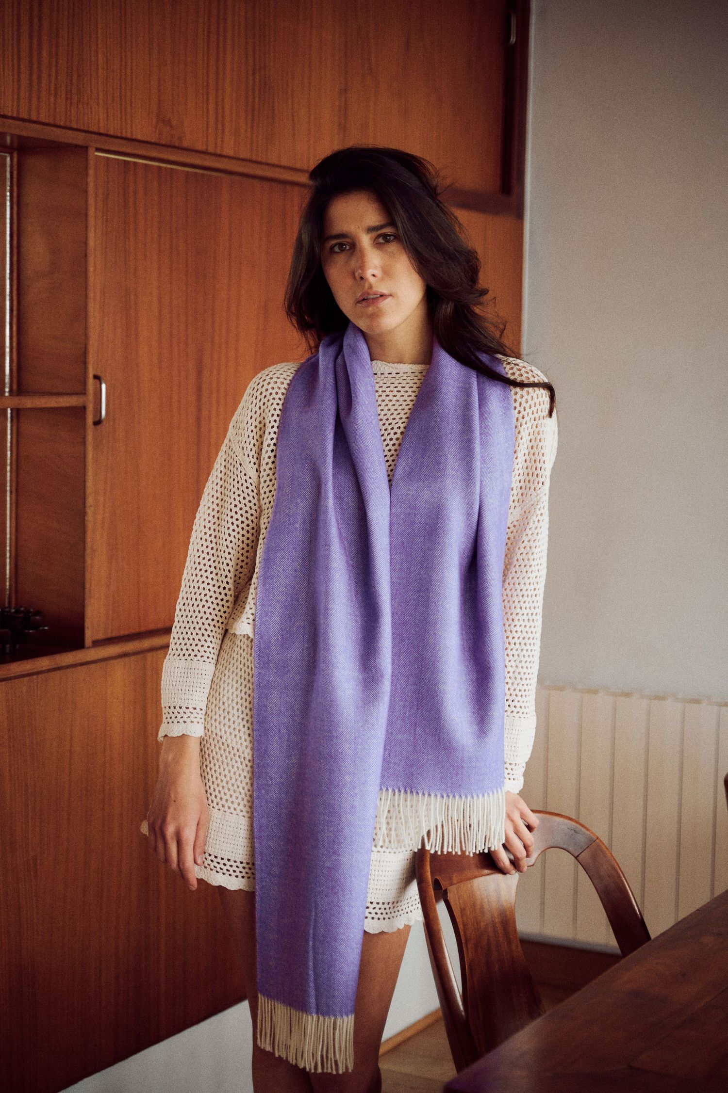 Fashion series featuring a purple scarf and white crochet top against wood paneled walls.