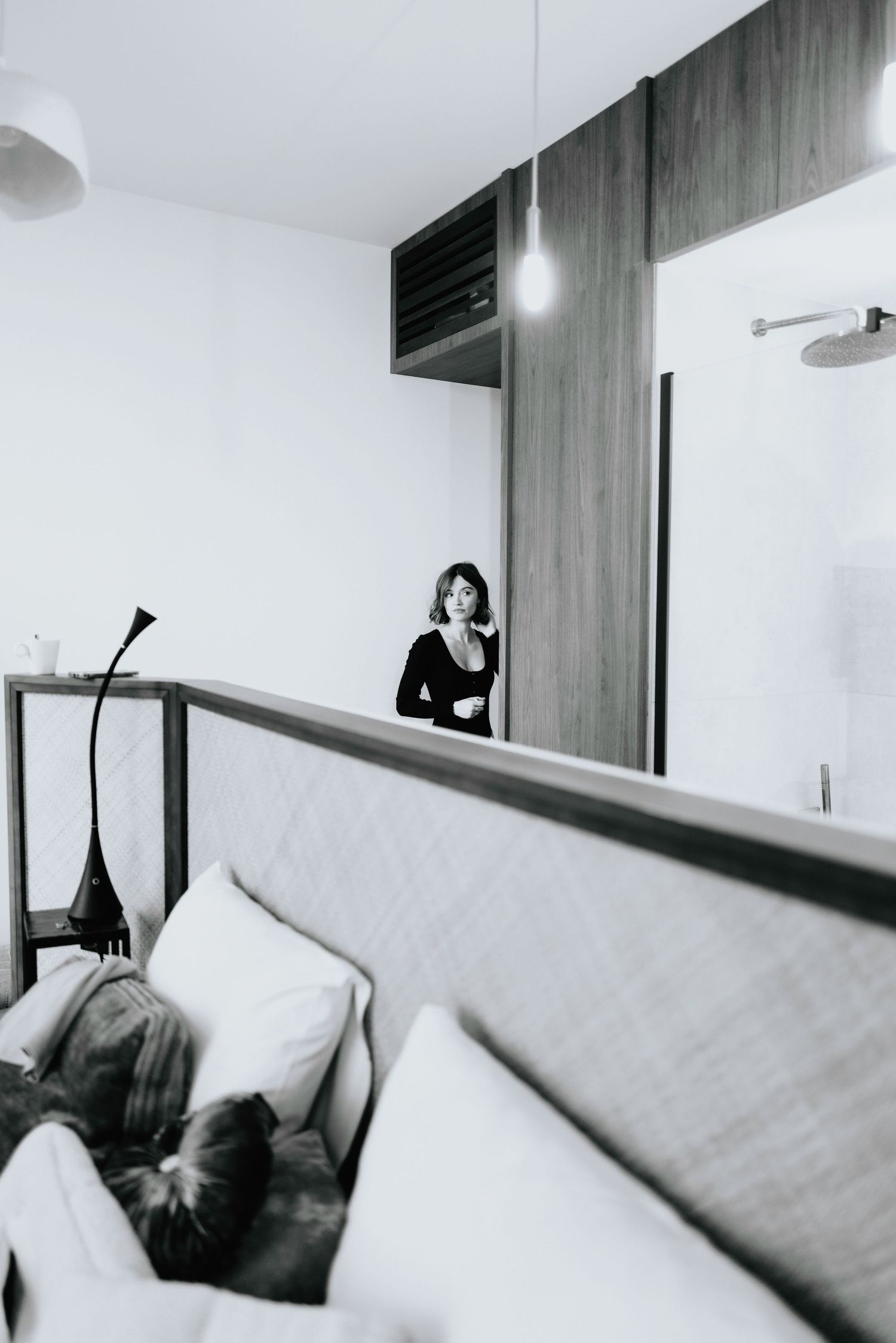 Minimalist interior scene with couch and cat silhouette in monochrome.