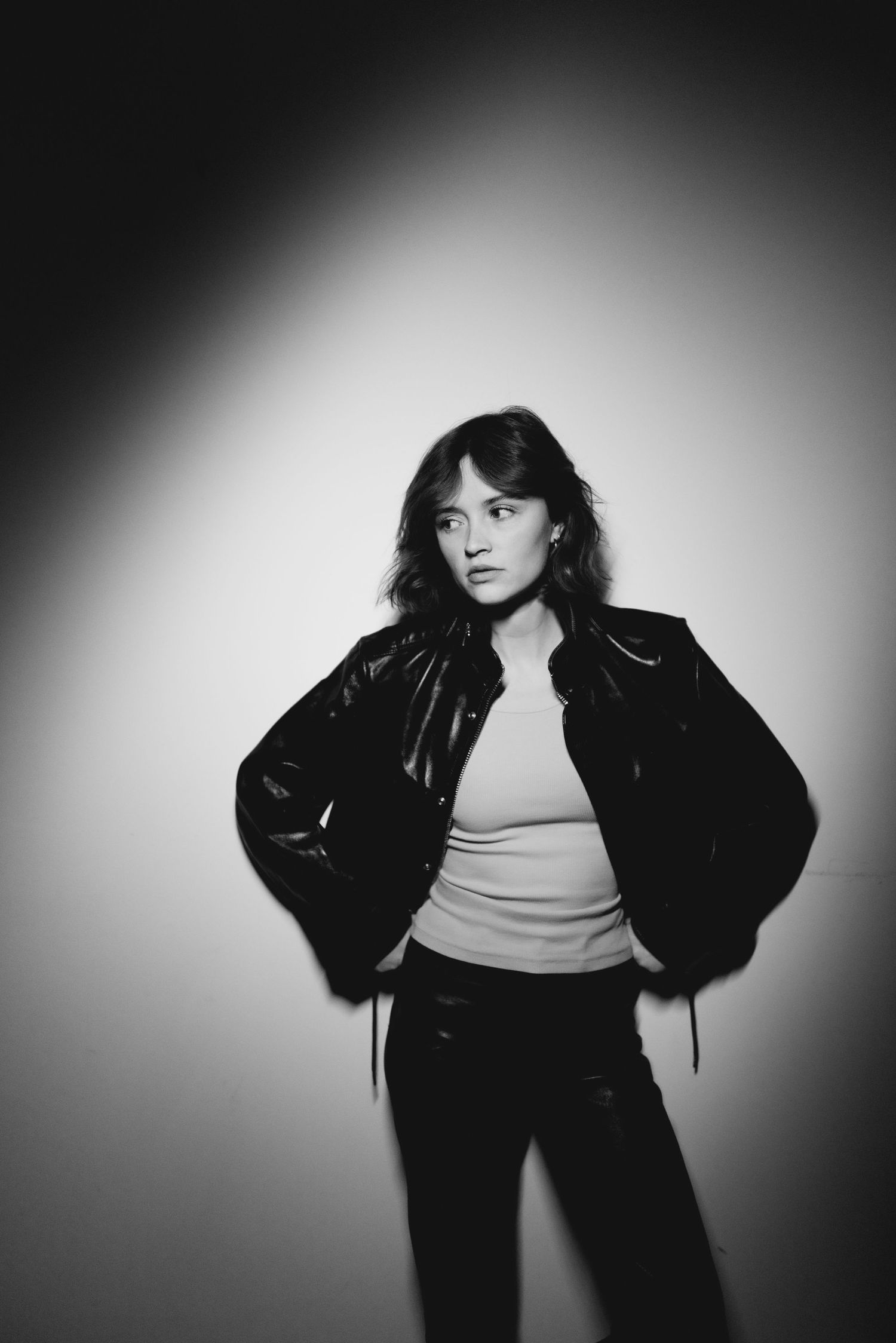 Dramatic black and white fashion portraits with spotlight effect.
