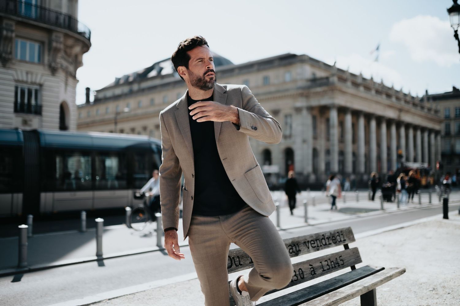 Urban lifestyle photography of a person in casual business attire exploring city architecture.
