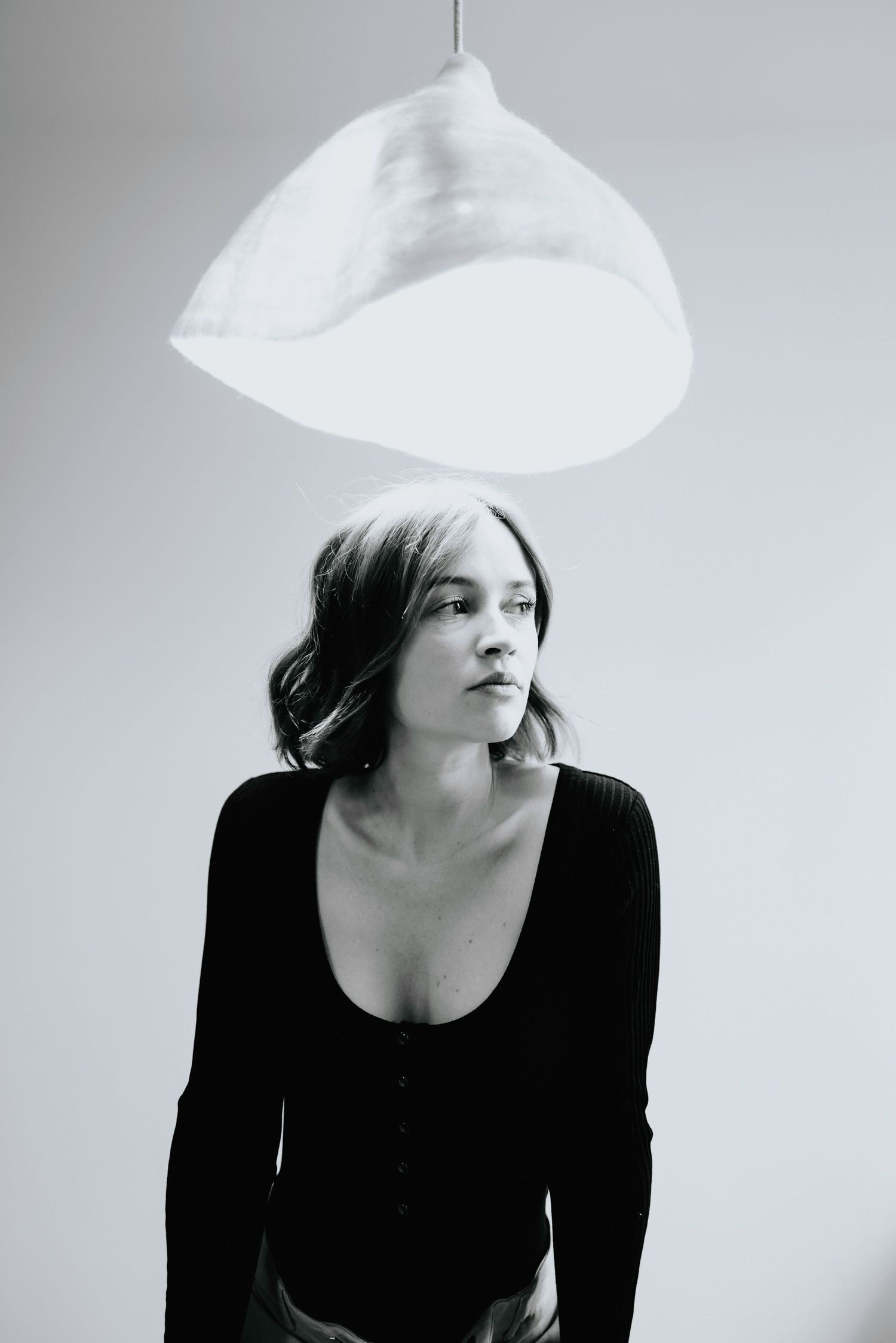 Artistic black and white portraits with white hat creating dramatic shadows.
