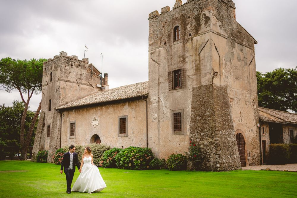 Historic stone church and castle architecture creates dramatic wedding venue backdrop.