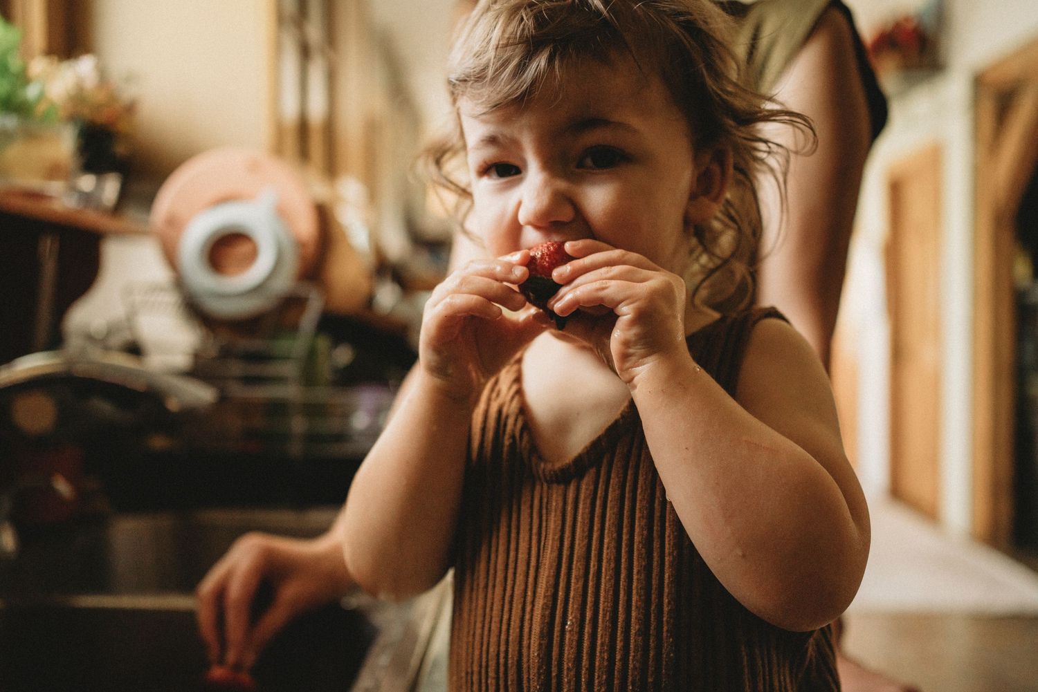 A candid kitchen moment showing expressions of joy and playfulness.