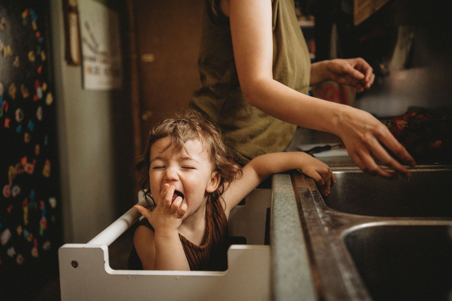 Playful kitchen scene with someone peeking through the counter space.