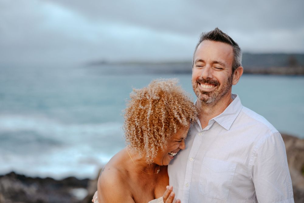 Maui Natural Couples Photography- A woman laughs into her partner while acting naturally during photo shoot