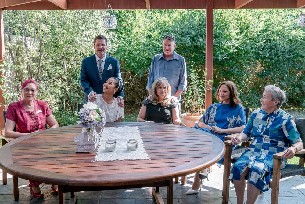 elopement group mature bride and groom with witnesses and celebrant in backyard