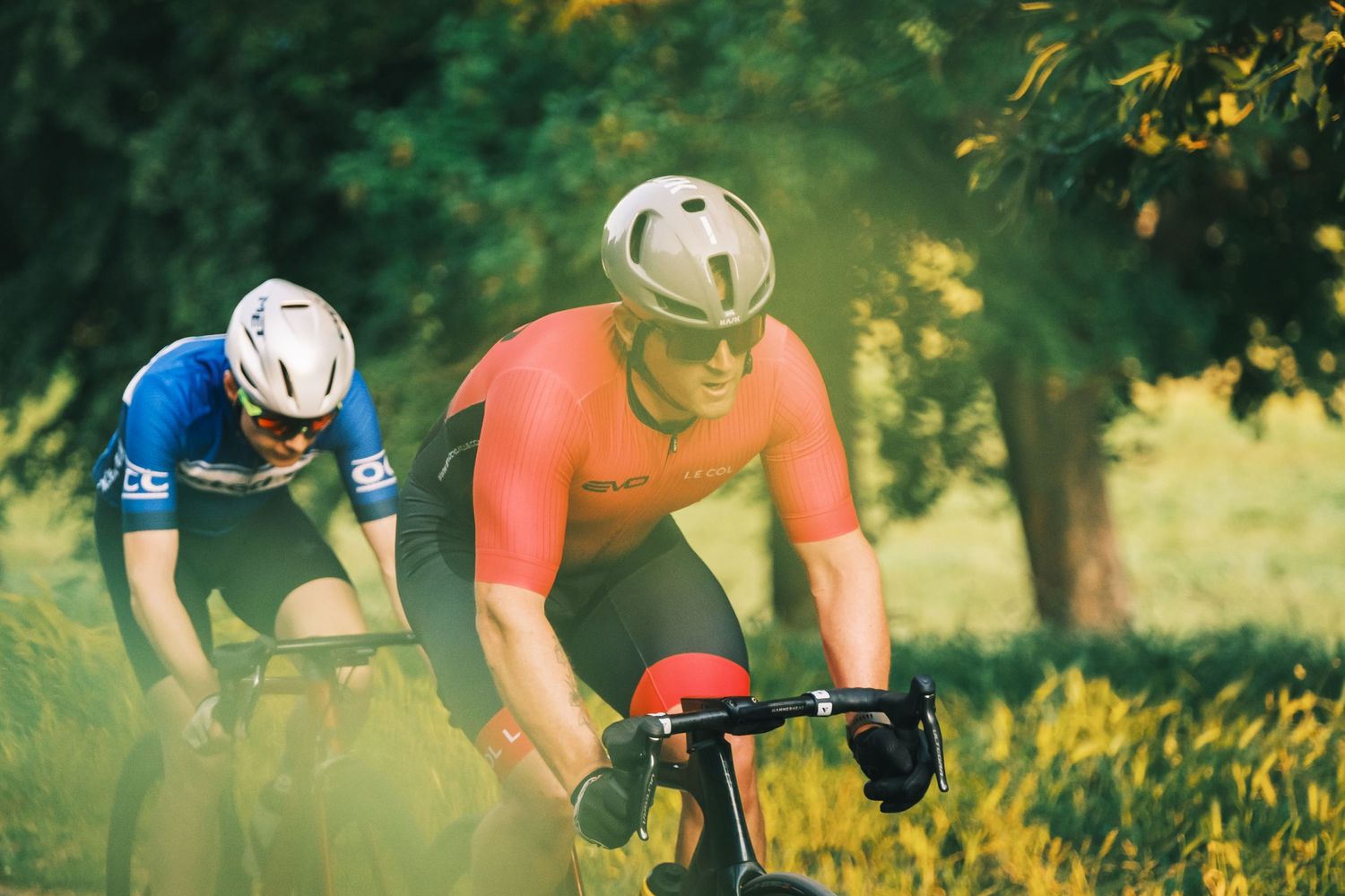 Photo shows two cyclists racing around Preston Park near Brighton with the sun setting