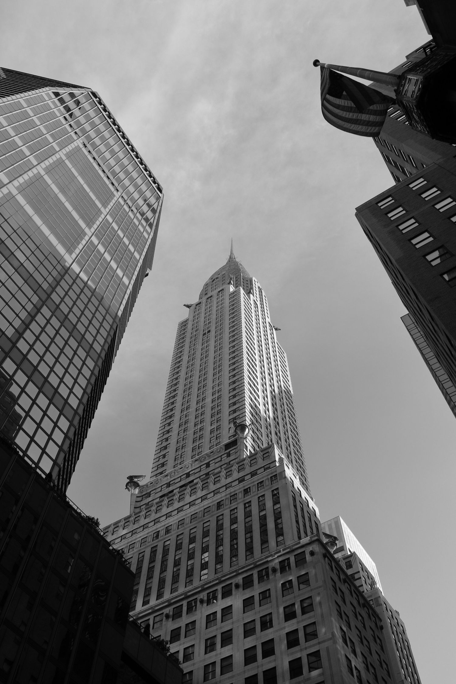 Looking up at the Chrysler Building in black and white with dramatic perspective.