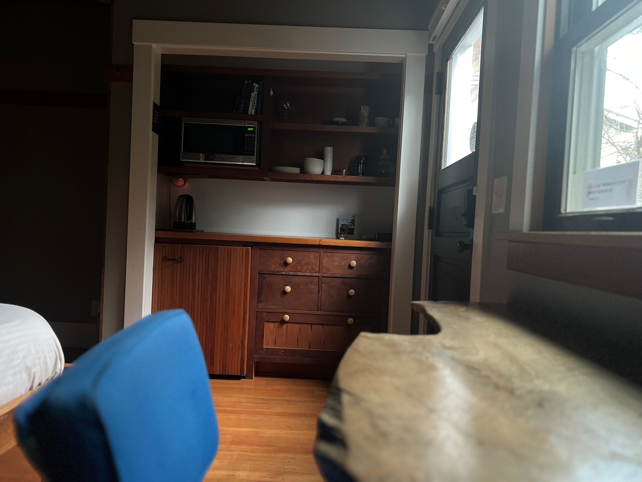 Interior room view with hardwood floors and blue furniture visible.