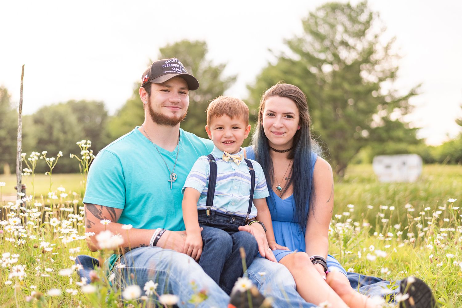 Family sitting in daisy patch in Clarion Pennsylvania