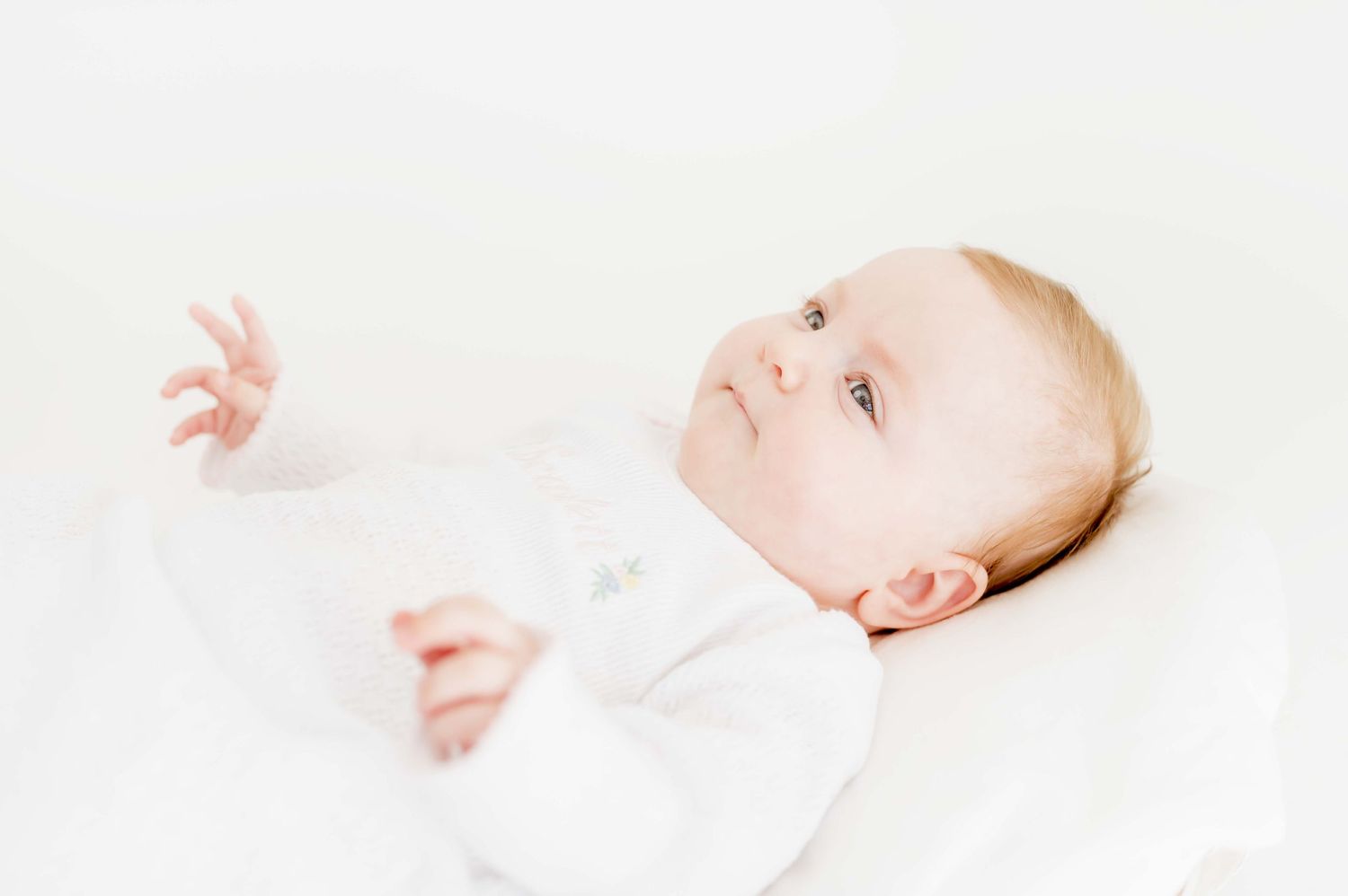 three month old taking baby milestone photos in an all natural light studio in houston texas