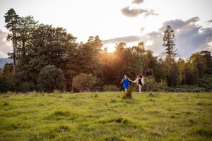 Holly and Zoe engagement at Tarn How's, The Lake District - running from the setting sun