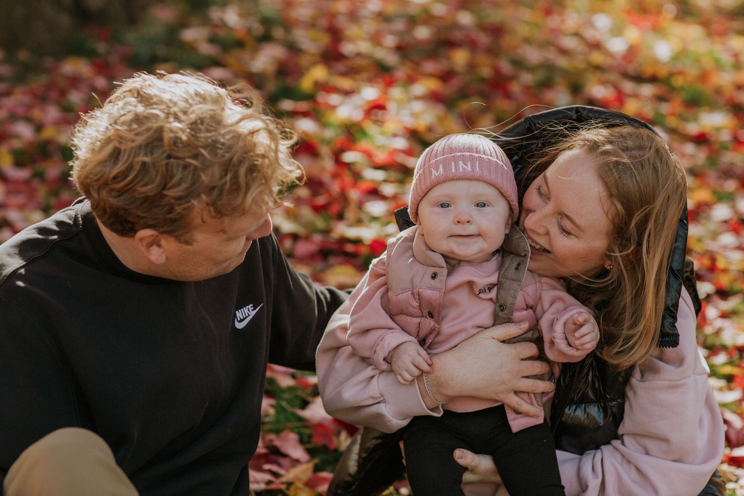 Sweet family moments photographed in sequence against colorful autumn foliage.
