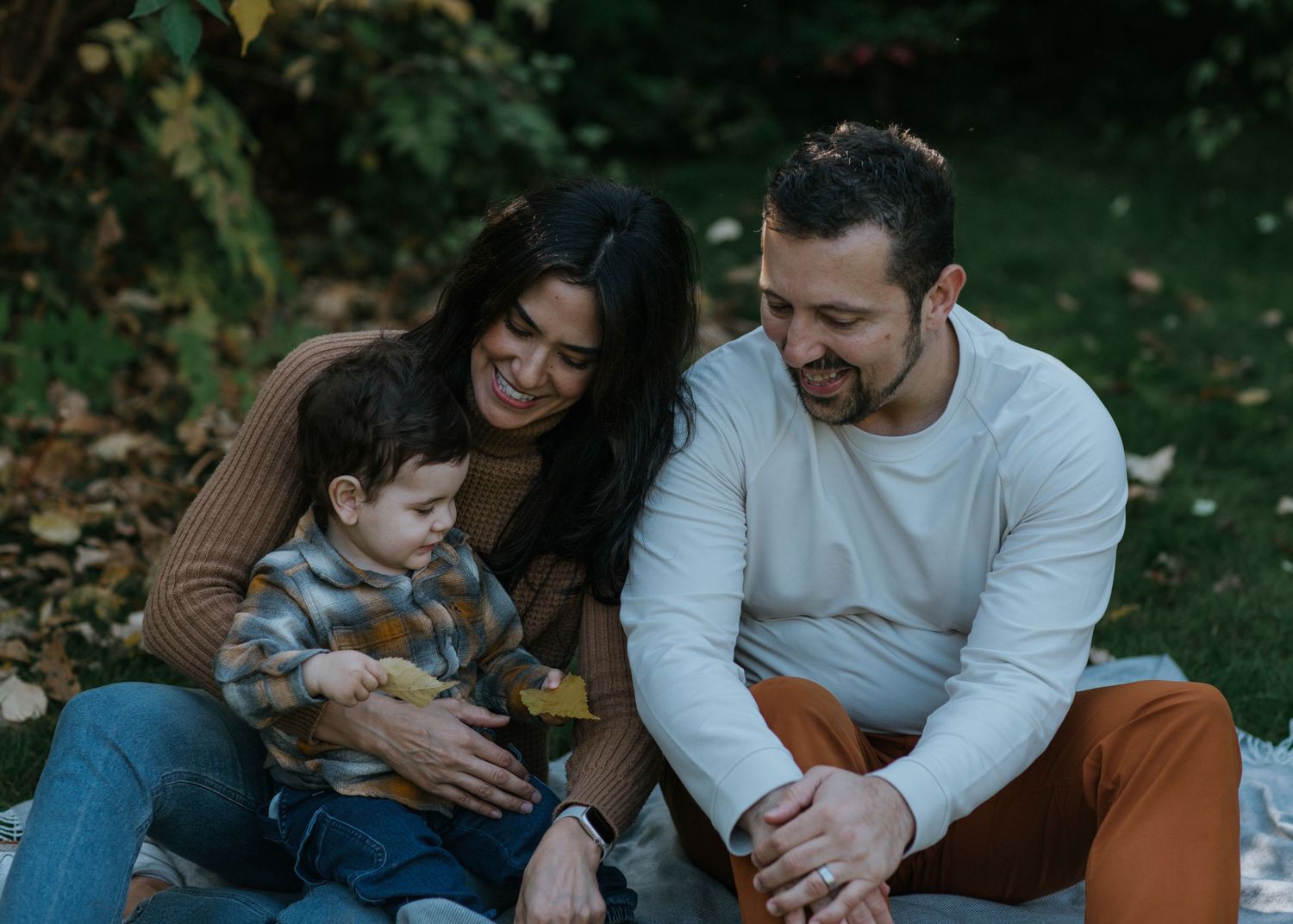 Joyful family immersed in the beauty of vibrant fall colours near Ottawa, ON.