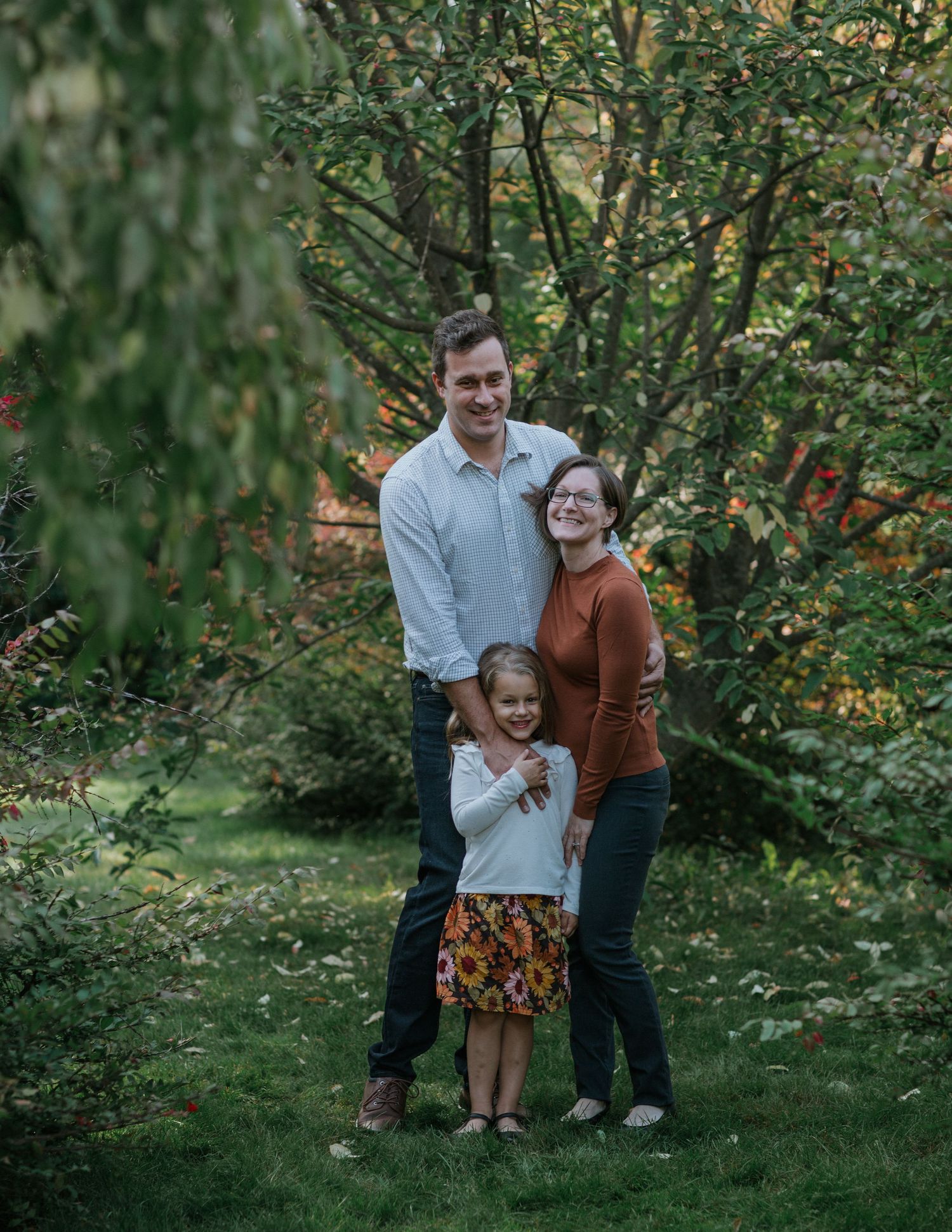 Joyful family immersed in the beauty of vibrant fall colours near Ottawa, ON.