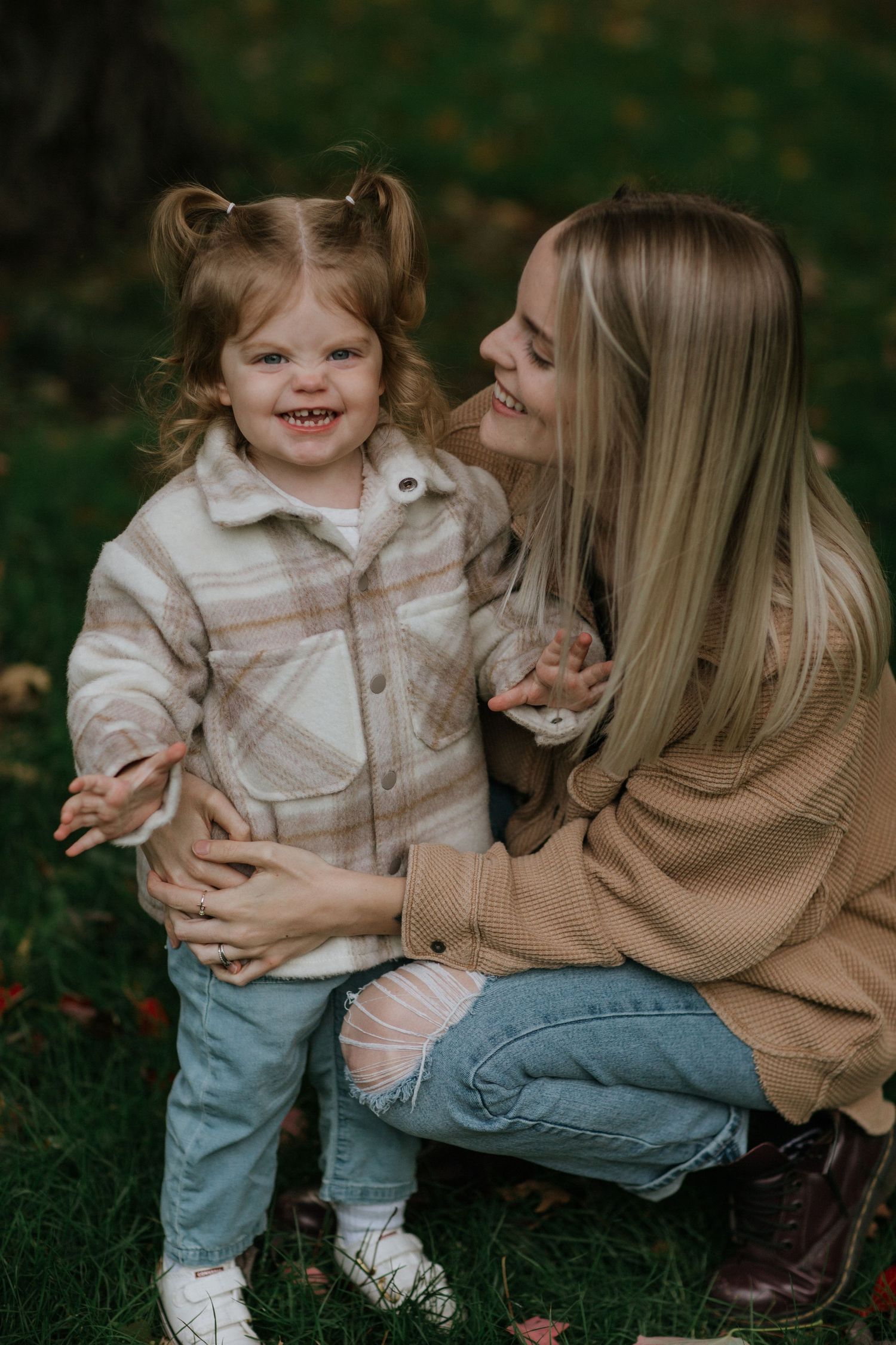Mom and daughter immersed in the beauty of vibrant fall colours near Ottawa, ON.