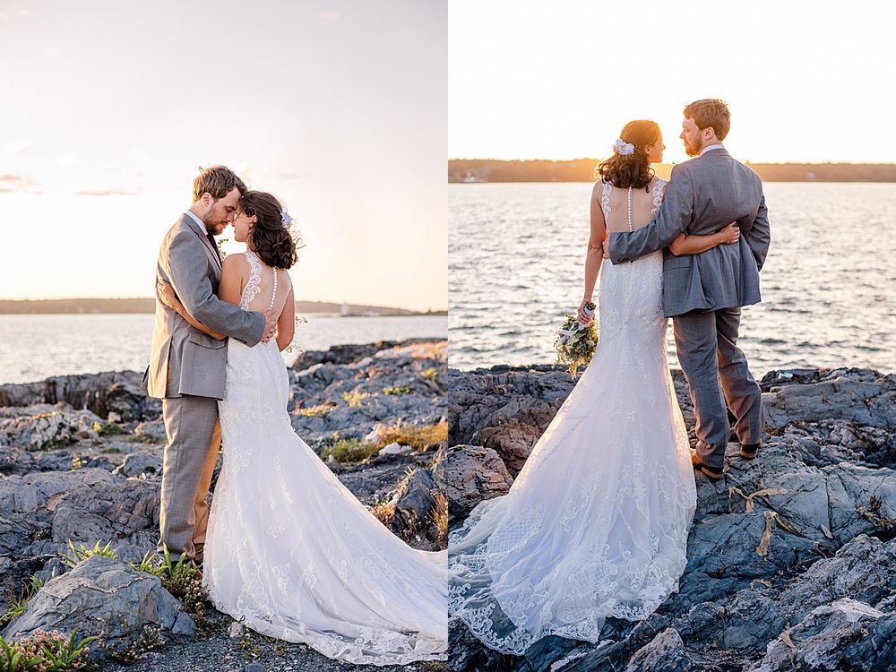 Romantic wedding couple embraces on rocky coastline at sunset with flowing white dress and gray suit.