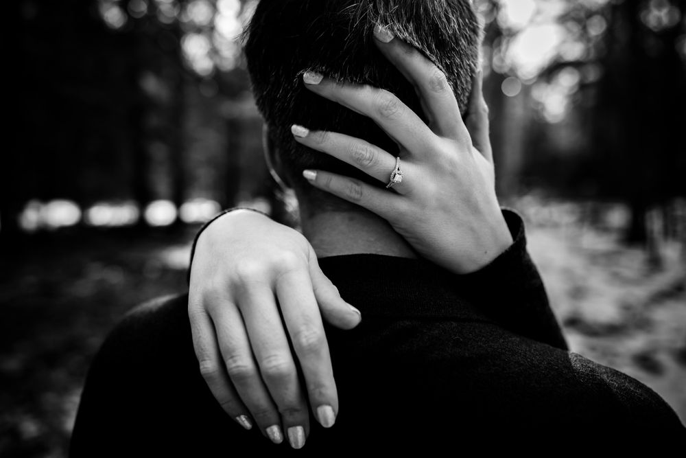 Close-up details of hands and intimate embraces during a winter engagement session.