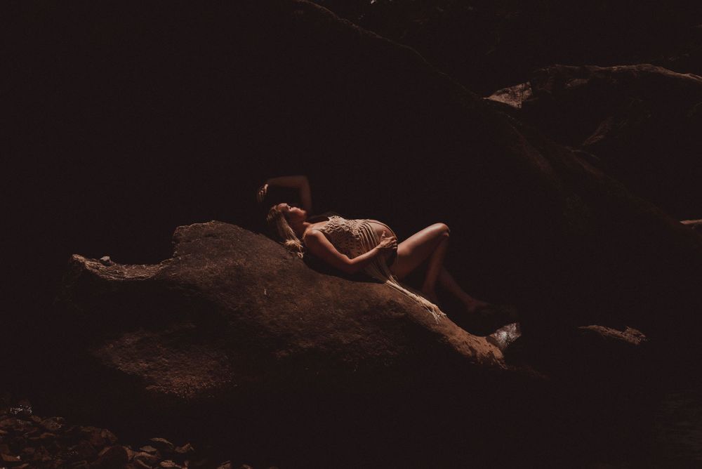 Artistic silhouette photograph on dark rocks in minimalist style.