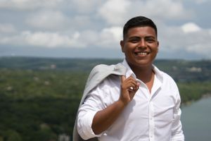 Mexican male smiles outside