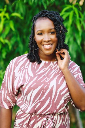 black female plays with hair and smiles