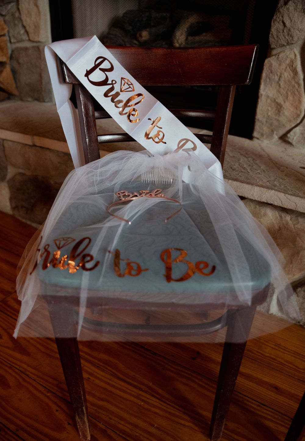 Decorated bridal chair with white tulle and rose gold 'Bride to Be' sash.