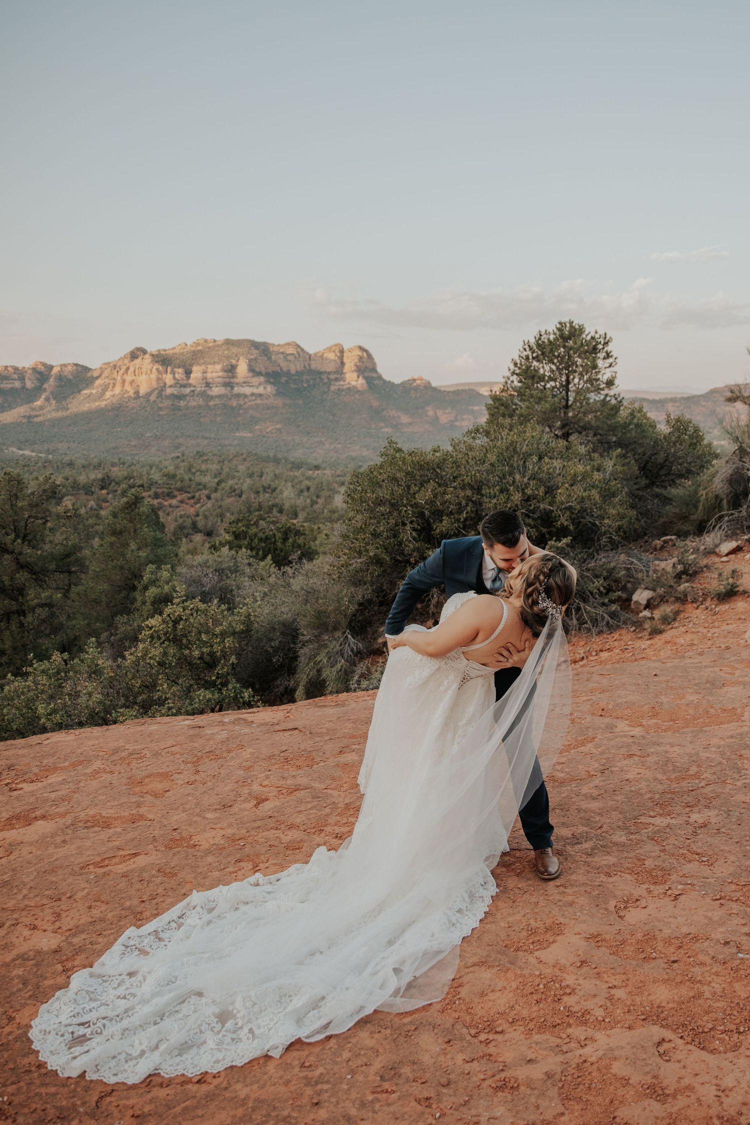 Couple eloping in Sedona, AZ with beautiful red rocks in the distance