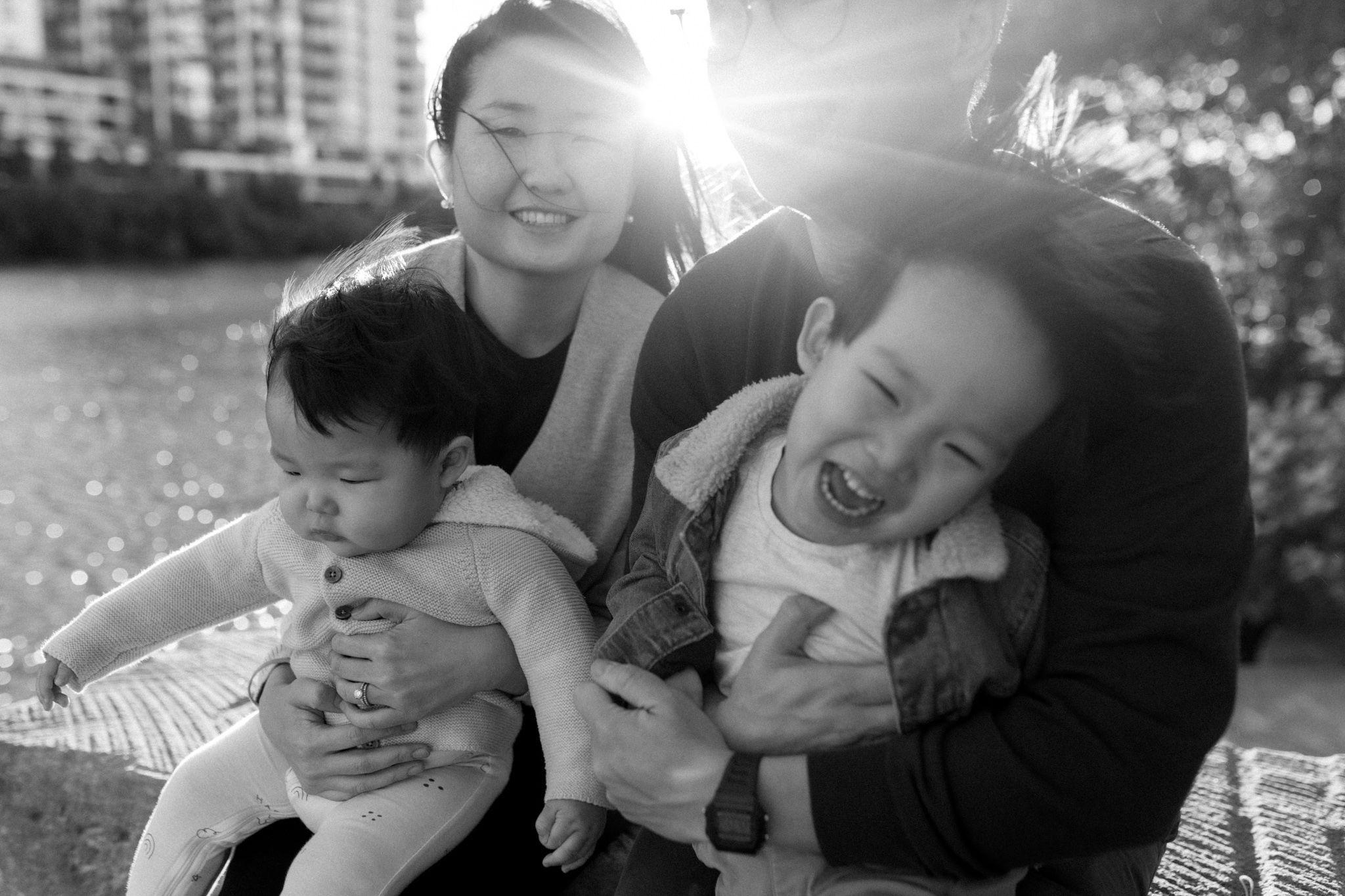 Family portraiture genuine smiles backlight