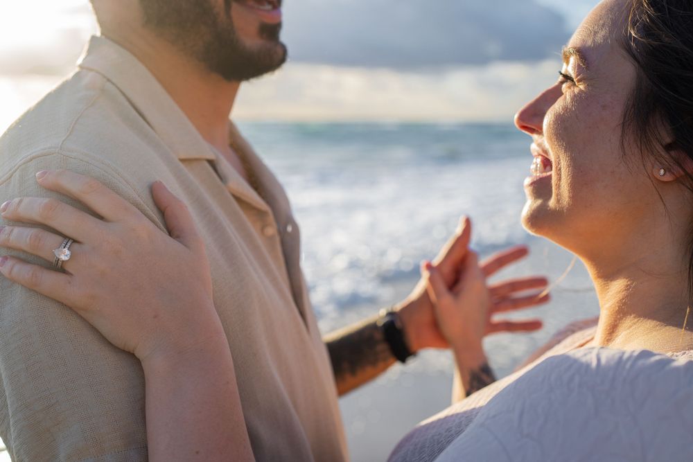 husband and wife dancing on the beach