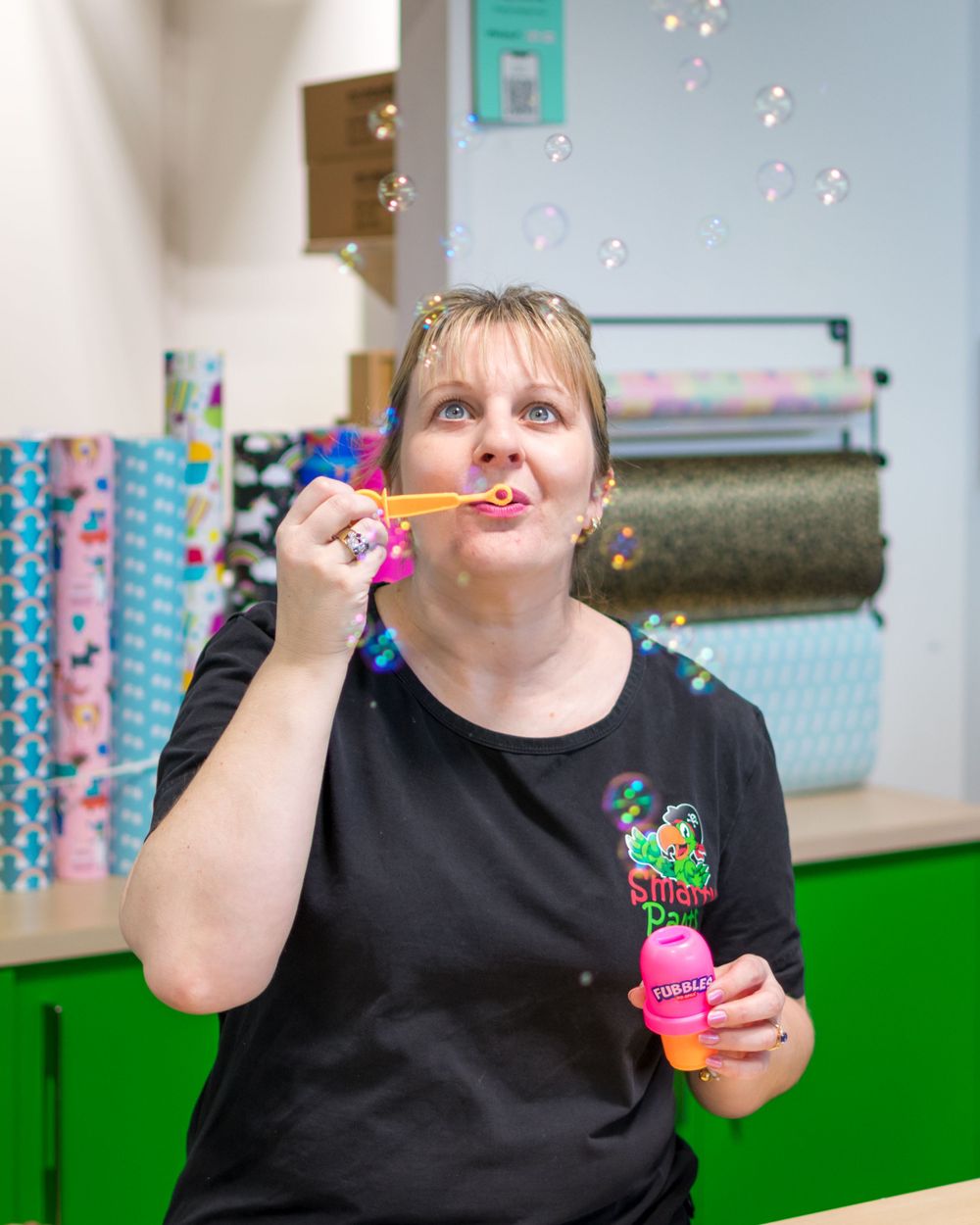 Sarah from Smartpants blow bubbles towards the photographer in her Wigram store in Christchurch.