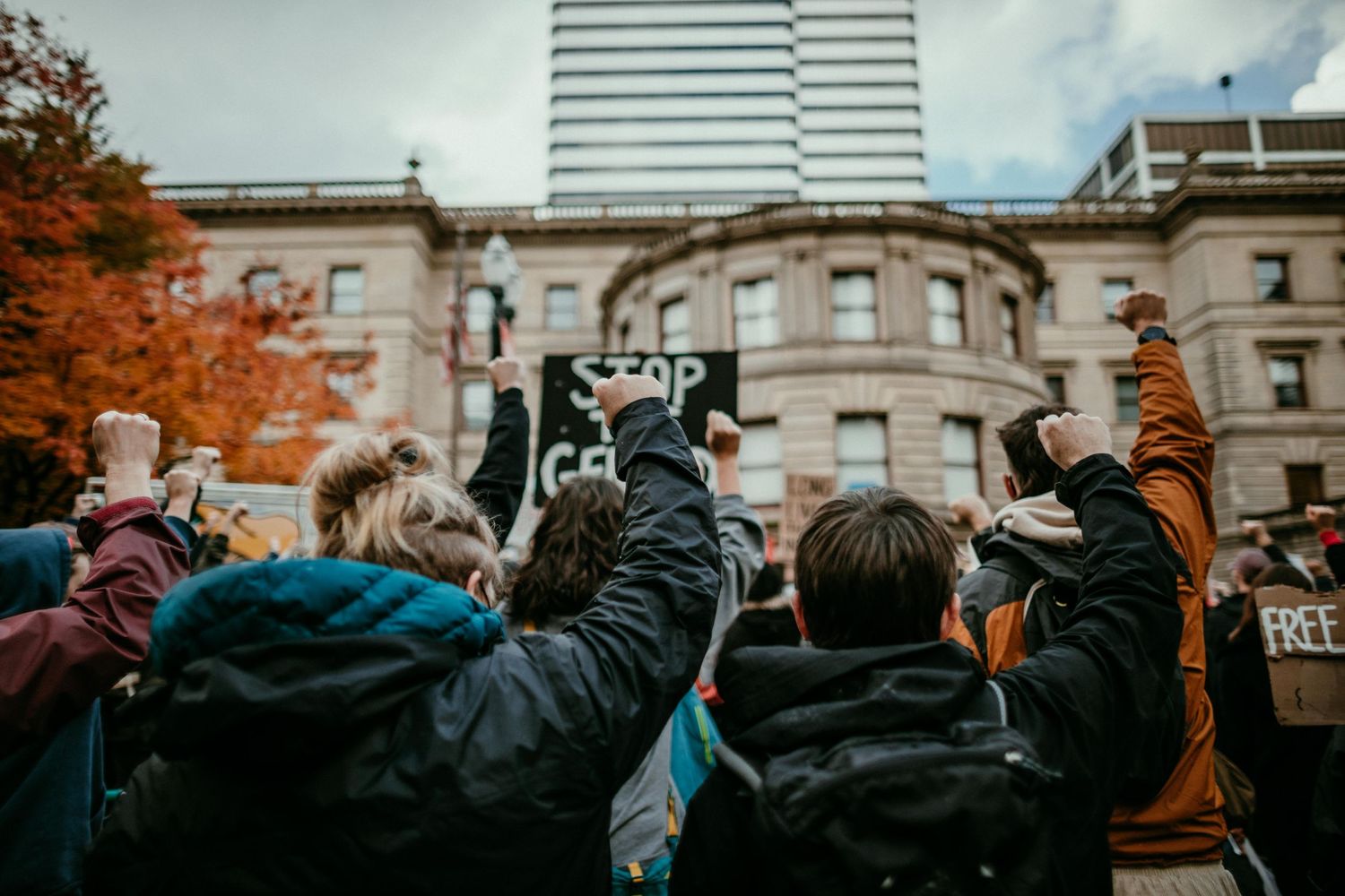 protesters hold up fists in solidarity at protest in portland oregon photojournalism