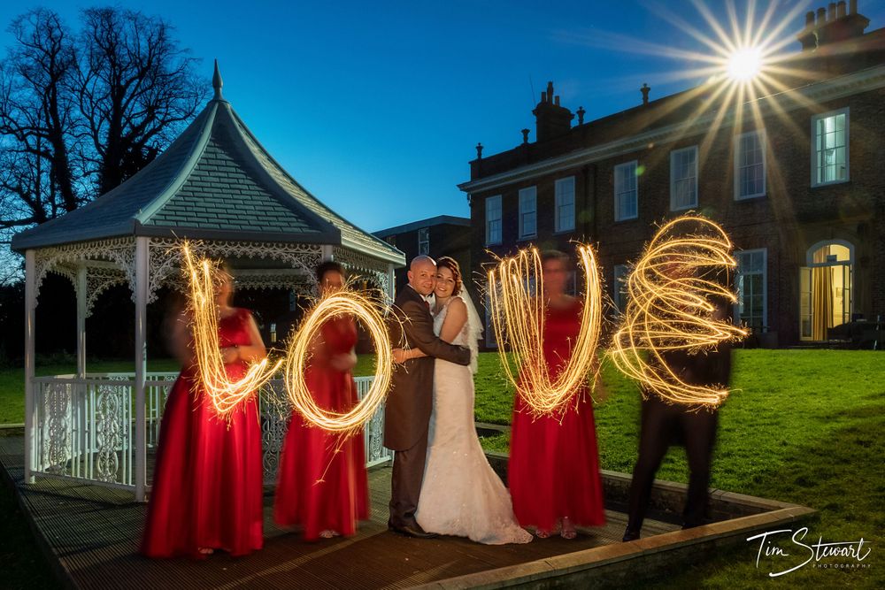 Wedding party at night outside Blackwell Grange, Darlington spelling 'LOVE' with sparklers