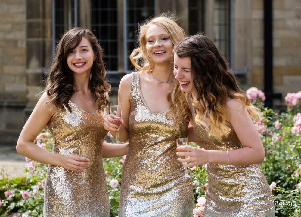 Bridesmaids laughing in front of Gisborough Hall, North Yorkshire