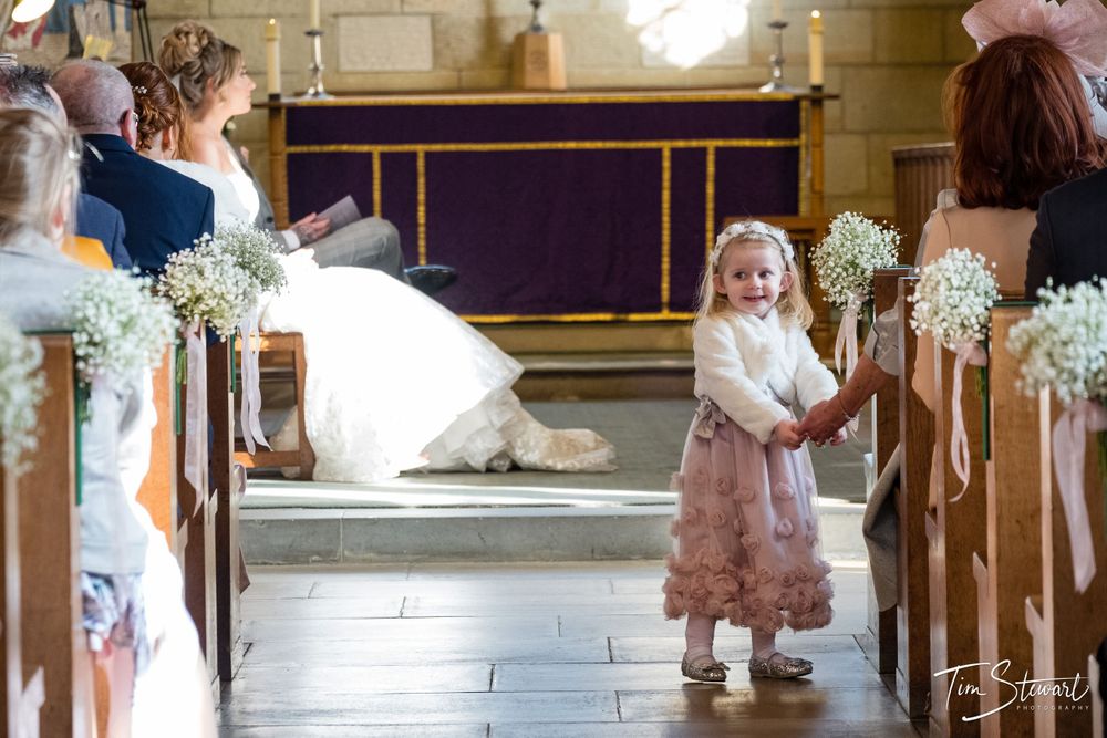 Flower girl smiling in church aisle, Saint Mary's Church, Nunthorpe, Middlesbrough