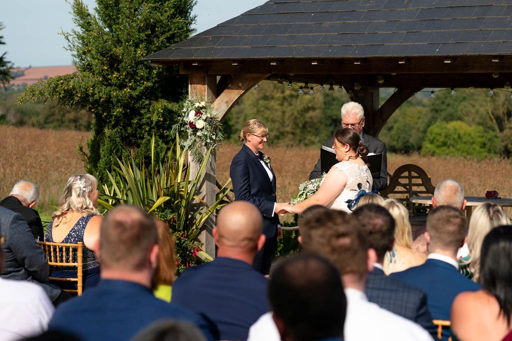 Wedding ceremony of two LGBTQ Brides at Harefield Barn, Devon
