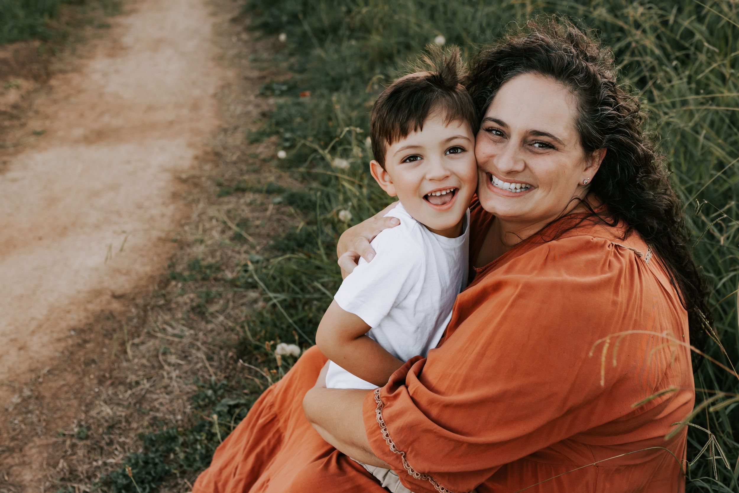 Canberra family photographer. National Arboretum.  Photo of mother and child hugging, earth tone edit.